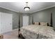 Charming bedroom featuring a four-poster bed, paneled walls, and two closets at 2134 N Alabama St, Indianapolis, IN 46202