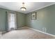 Neutral bedroom featuring textured ceiling, neutral walls, carpet, and a window at 2134 N Alabama St, Indianapolis, IN 46202