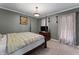 Well-lit bedroom featuring a four-poster bed, paneled walls, and neutral carpet at 2134 N Alabama St, Indianapolis, IN 46202