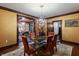 Elegantly appointed dining room features a glass-top table, seating for six, and an exquisite chandelier at 2134 N Alabama St, Indianapolis, IN 46202
