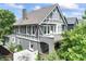 Charming gray Tudor-style home with white trim, surrounded by lush landscaping at 2134 N Alabama St, Indianapolis, IN 46202