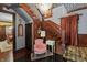 Beautiful foyer with dark wood staircase, chandelier, and charming vintage furnishings for a warm welcome at 2134 N Alabama St, Indianapolis, IN 46202