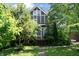 Charming two-story home with well-manicured lawn, mature trees, and inviting front porch at 2134 N Alabama St, Indianapolis, IN 46202
