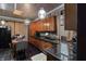 Well-lit kitchen featuring black countertops and tiled flooring, with an adjacent dining space at 2134 N Alabama St, Indianapolis, IN 46202