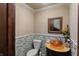 Cozy powder room features a unique vessel sink, decorative mirror, and tiled wall accents at 2134 N Alabama St, Indianapolis, IN 46202