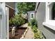 Well-manicured side yard with gravel path, tasteful landscaping, and decorative angel statue at 2134 N Alabama St, Indianapolis, IN 46202
