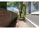 A gravel side yard with tasteful landscaping and a wooden fence separating the properties at 2134 N Alabama St, Indianapolis, IN 46202