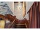 Grand staircase featuring wood railing, chandelier lighting, and elegant design accents at 2134 N Alabama St, Indianapolis, IN 46202