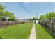 Expansive backyard featuring a lush lawn, a storage shed, and a defined pathway at 2230 Pleasant St, Indianapolis, IN 46203