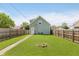 Spacious backyard featuring a well-maintained lawn and a charming fire pit area at 2230 Pleasant St, Indianapolis, IN 46203