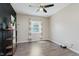 Bedroom with a window, a black ceiling fan and a black accent wall at 2230 Pleasant St, Indianapolis, IN 46203