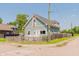 View of the charming home with light blue siding, white trim and fenced yard on a corner lot at 2230 Pleasant St, Indianapolis, IN 46203