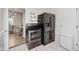 Kitchen with black refrigerator and black range stove; dining room in background at 2230 Pleasant St, Indianapolis, IN 46203