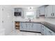 Kitchen featuring grey cabinets, updated black hardware, and white backsplash at 2230 Pleasant St, Indianapolis, IN 46203