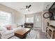 Bright living room with a white sofa, wood floors, ceiling fan, and natural light at 2230 Pleasant St, Indianapolis, IN 46203