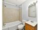Bright bathroom featuring a shower-tub combination with a cream tile surround and single sink vanity at 2966 N Olney St, Indianapolis, IN 46218