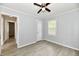 Bedroom with gray walls, wood-look flooring, ceiling fan, and interior doors at 2966 N Olney St, Indianapolis, IN 46218
