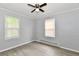 Bedroom with gray walls, wood-look flooring, ceiling fan, and two windows at 2966 N Olney St, Indianapolis, IN 46218