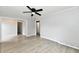 Bright living room with gray walls, modern ceiling fan, and light wood-look flooring at 2966 N Olney St, Indianapolis, IN 46218