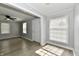 Spacious living room with gray walls, light wood-look flooring, and natural light from multiple windows at 2966 N Olney St, Indianapolis, IN 46218