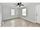 Inviting living room with gray walls, two windows, light-colored flooring, and ample natural light at 2966 N Olney St, Indianapolis, IN 46218