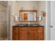 Bright bathroom with double sink vanity, granite countertop, framed mirror, and tiled shower with glass door at 31 N Bolton Ave, Indianapolis, IN 46219