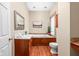 Bathroom featuring a soaking tub, vanity sink, mirror, and wood flooring at 31 N Bolton Ave, Indianapolis, IN 46219