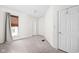 Cozy bedroom with neutral paint, plush carpet and a window with blinds at 31 N Bolton Ave, Indianapolis, IN 46219