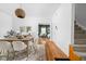 Bright dining room featuring hardwood floors, modern light fixture, and stylish decor with view of living room at 31 N Bolton Ave, Indianapolis, IN 46219
