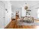 Bright dining room featuring hardwood floors, modern light fixture, and stylish decor with an open doorway to the kitchen at 31 N Bolton Ave, Indianapolis, IN 46219