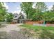 Charming home featuring an expansive deck, a playset and a long gravel driveway at 31 N Bolton Ave, Indianapolis, IN 46219