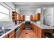 Traditional kitchen featuring wood cabinets, granite countertops, and stainless steel appliances at 31 N Bolton Ave, Indianapolis, IN 46219