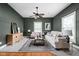 Comfortable living room featuring hardwood floors, neutral paint, with modern furnishings and stylish decor and lots of light at 31 N Bolton Ave, Indianapolis, IN 46219