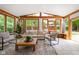 Sun-filled living room with vaulted ceiling, wooden beams, hardwood windows, comfortable furniture, and decorative rug at 31 N Bolton Ave, Indianapolis, IN 46219