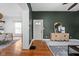 Open-concept living area featuring hardwood floors, neutral paint, and ample natural light with open doorway to dining room at 31 N Bolton Ave, Indianapolis, IN 46219