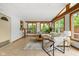 Bright living room boasts hardwood trim, vaulted ceilings, modern furnishings, neutral décor, and abundant natural light at 31 N Bolton Ave, Indianapolis, IN 46219