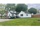 Spacious backyard, wooden deck, and white home exterior, providing ample outdoor space at 3324 S Walnut St, Muncie, IN 47302
