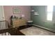 Well-lit Bedroom with wood floors features a gold crib and wicker dresser at 3324 S Walnut St, Muncie, IN 47302