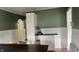 Dining area featuring white cabinets, plenty of storage, and attractive green and white walls at 3324 S Walnut St, Muncie, IN 47302