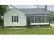 Charming home featuring a lovely screened-in porch, manicured lawn, and appealing front yard landscaping at 3324 S Walnut St, Muncie, IN 47302
