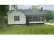 Charming home exterior featuring a well-manicured lawn and inviting screened-in porch at 3324 S Walnut St, Muncie, IN 47302