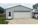 Detached garage with a large, white door and adjacent entryway at 3324 S Walnut St, Muncie, IN 47302