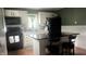 Kitchen featuring black appliances, a breakfast bar with seating, and attractive white cabinets at 3324 S Walnut St, Muncie, IN 47302