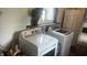 Bright laundry room features modern white washer and dryer with updated shelving and decor at 3324 S Walnut St, Muncie, IN 47302