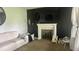 Comfortable living room includes fireplace with white mantel and lots of natural light at 3324 S Walnut St, Muncie, IN 47302