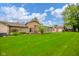 Expansive backyard with lush green lawn and mature trees, perfect for outdoor activities at 3537 Woodglen Way, Anderson, IN 46011