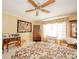 Bedroom featuring a floral bedspread, wood furnishings, a ceiling fan and natural light at 3537 Woodglen Way, Anderson, IN 46011