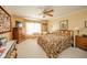 Bedroom showcasing a floral bedspread, wood furnishings, and natural light from the window at 3537 Woodglen Way, Anderson, IN 46011