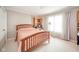 Comfortable bedroom featuring a wooden bed frame, plush pink bedding, and bright natural light at 3537 Woodglen Way, Anderson, IN 46011