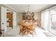 Bright dining room features wood table, chairs, built-in hutch, and sliding glass doors to the patio at 3537 Woodglen Way, Anderson, IN 46011